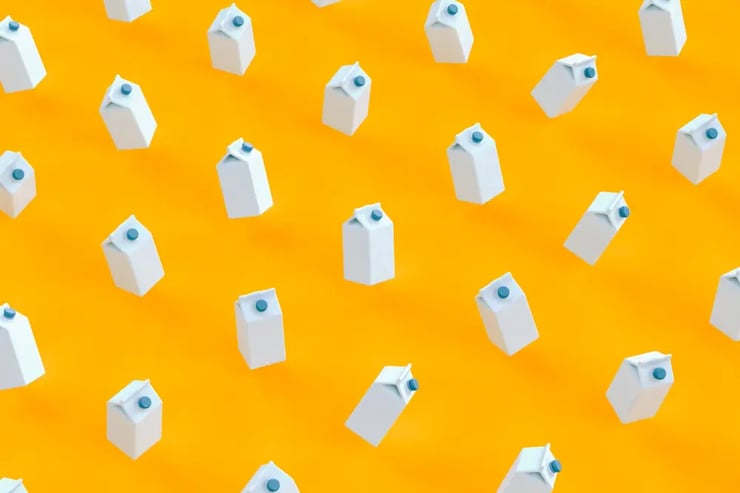 Assorted milk cartons on yellow backdrop