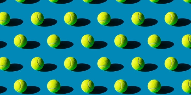 Rows of tennis balls on a dark blue background